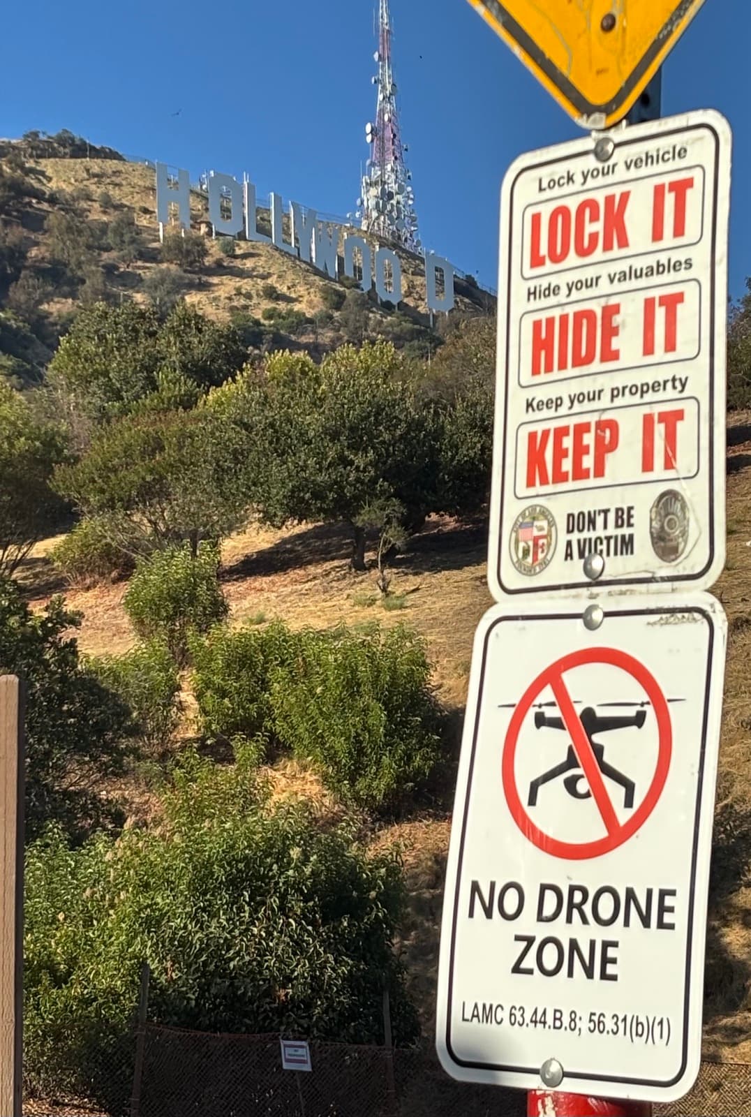 No Drone Zone sign posted below the Hollywood sign in Los Angeles